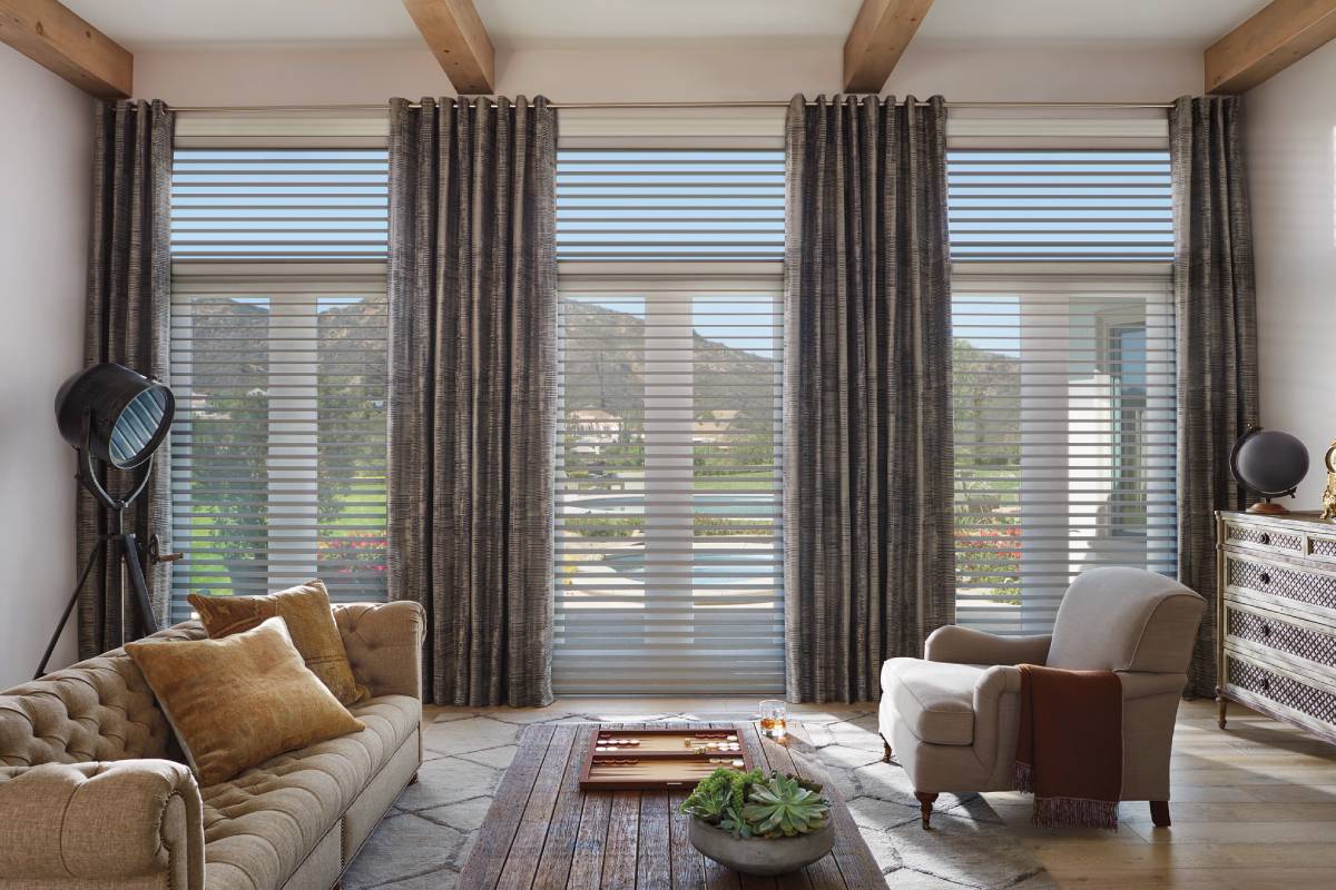 Silhouette® Sheer Shades layered with drapes in a living room near Eugene, OR